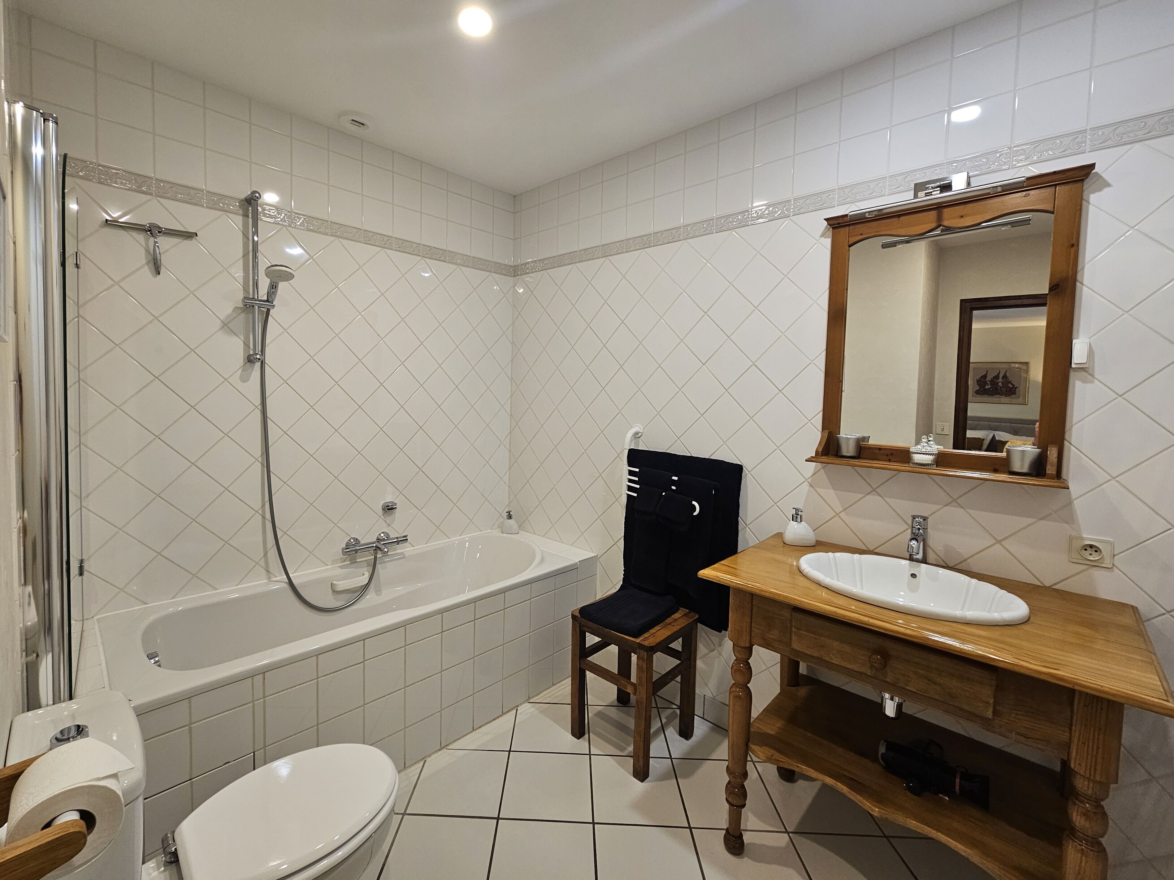 A bathroom with a bathtub, toilet, and sink.