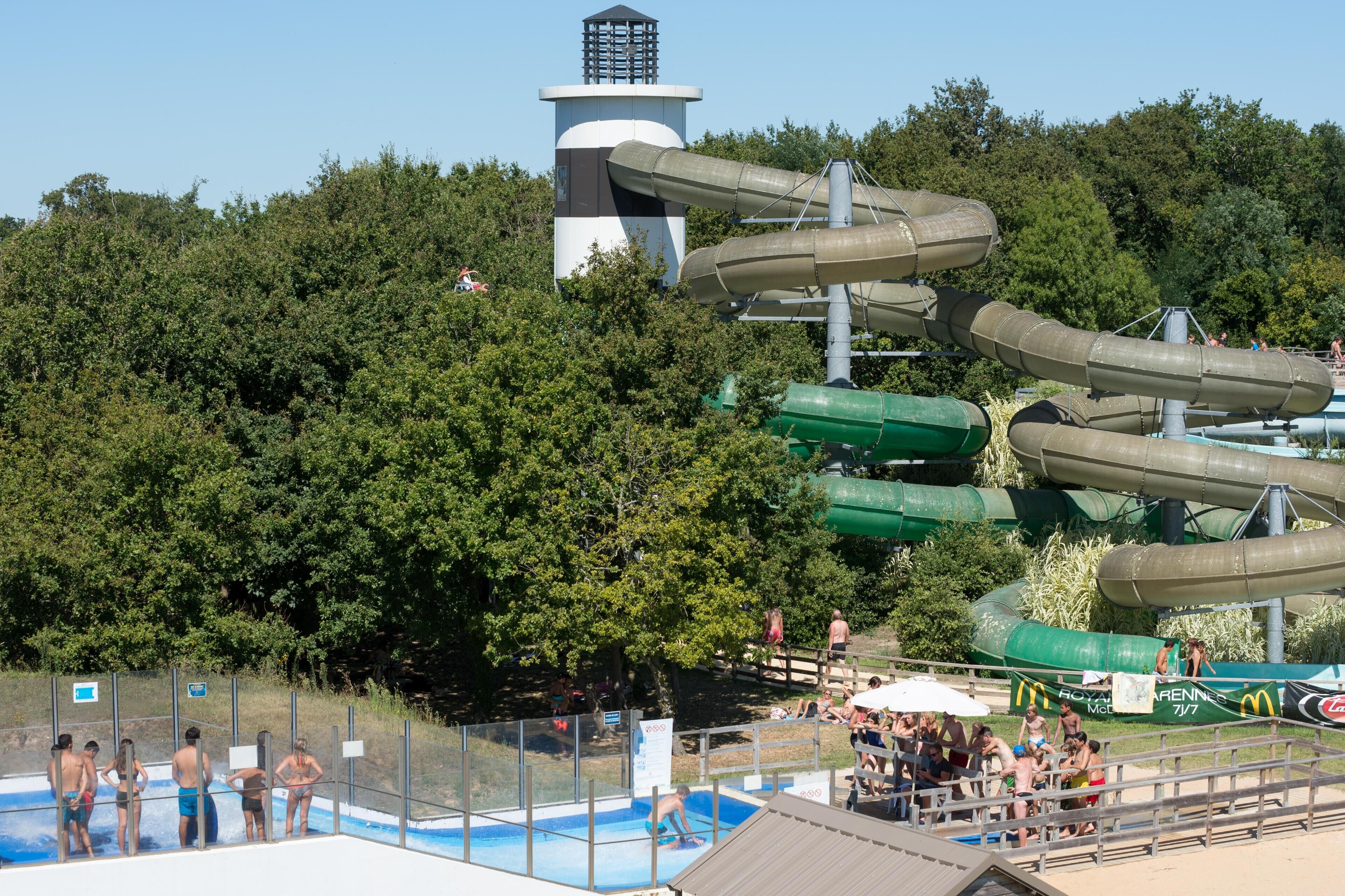 A water park with multiple water slides and a swimming pool.