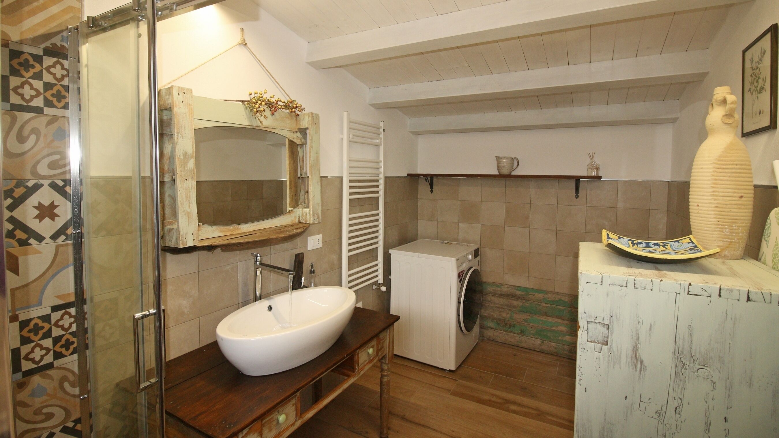 A bathroom with a large mirror, a sink, a toilet, and a shower.