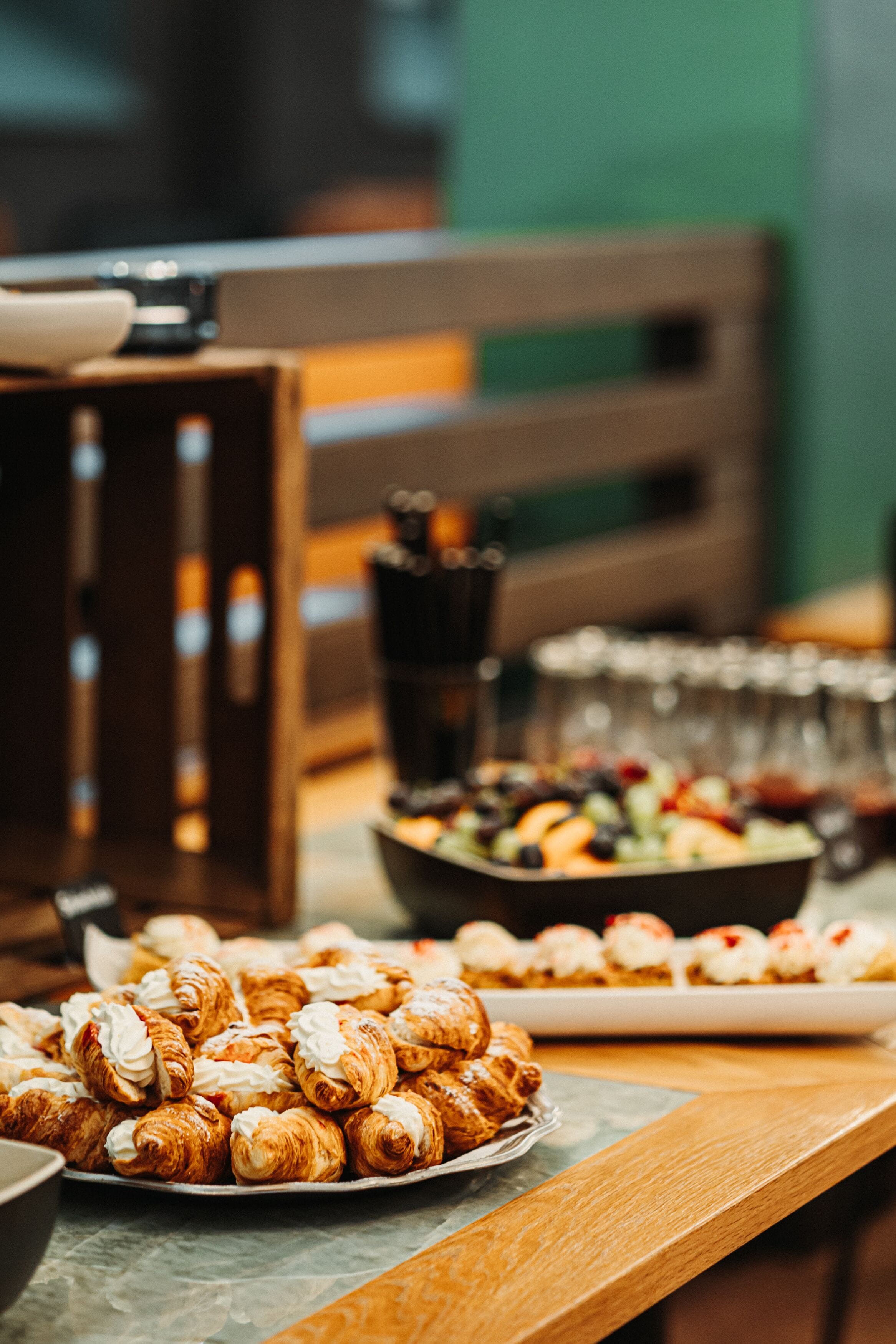 A buffet table with various pastries and a coffee station.