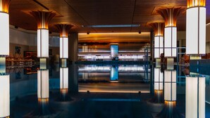 A spacious lobby with a large reflective pool, modern lighting, and a central digital display. - Hotel Kakola (Turku)