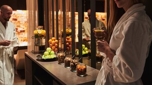 A buffet with various food items and beverages, including fruits, nuts, and drinks, in a well-lit indoor setting. - SCHLOSS Zermatt - CBD & Adaptogenic Spa and Sport Hotel (Zermatt)
