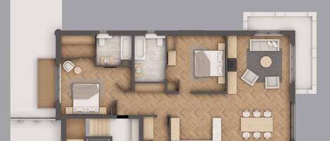 A floor plan of a hotel room with a bed, a sitting area with a table and chairs, a kitchenette, and a bathroom.