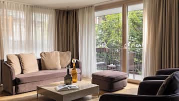 Luxury Suite Ground Floor | Living area | 70-cm flat-screen TV with cable channels, TV, heated floors