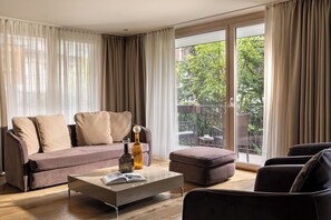 Luxury Suite Ground Floor | Living area | 70-cm flat-screen TV with cable channels, TV, heated floors