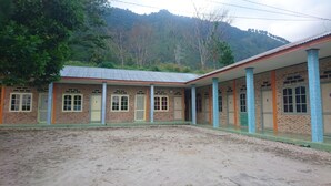 A building with a brick facade, multiple doors, and windows.