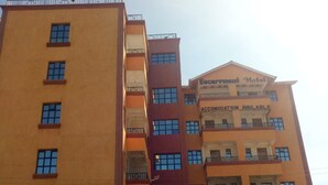 A multi-story building with a sign for "Accommodation Available" at the top. - Escarpment Motel - Adults Only (Mai Mahiu)