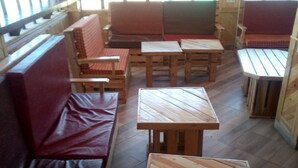 A seating area with wooden tables and benches, arranged in a casual layout. - Escarpment Motel - Adults Only (Mai Mahiu)