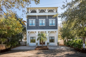 A two-story house with a front porch, a garage, and a driveway.
