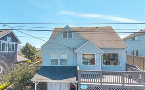 A two-story house with a front deck and a garage. - Spacious Beach Home for the whole family, 2 Blocks to Beach/Seaside Promenade (Seaside)