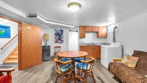A compact living space with a dining area, kitchenette, and a sofa. - Spacious Beach Home for the whole family, 2 Blocks to Beach/Seaside Promenade (Seaside)