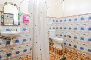 A bathroom with a sink, mirror, toilet, and shower curtain. - Green View Ubud Hostel Bali (Ubud)