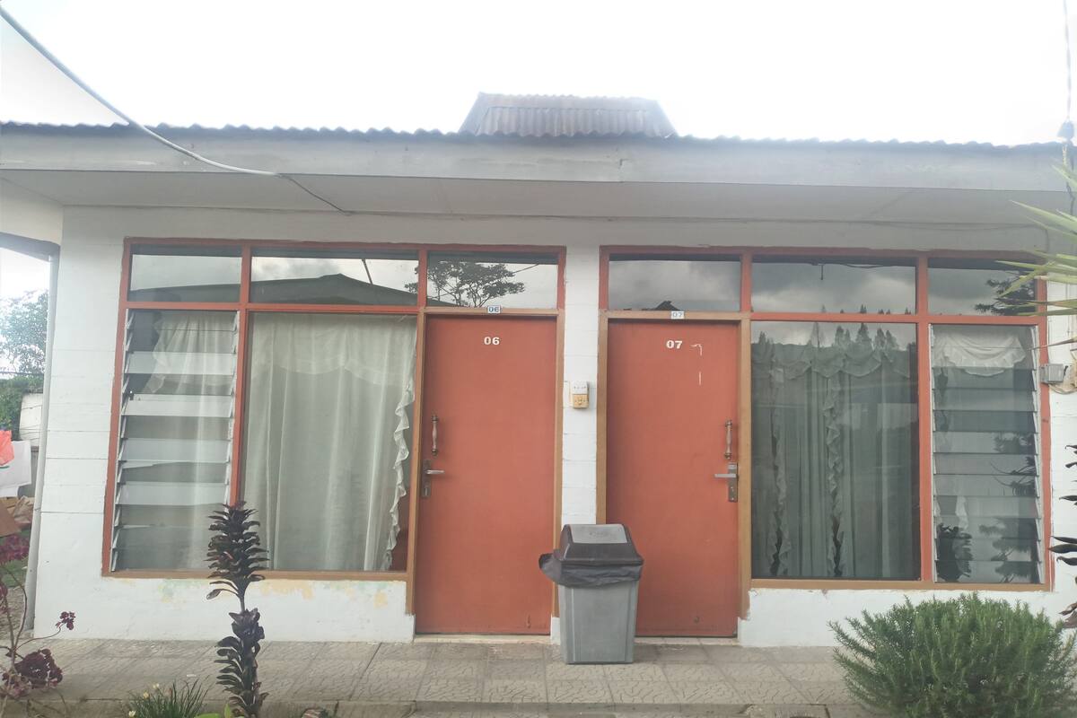 A building with two red doors, numbered 06 and 07, and large windows.