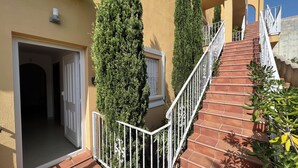 A building with a staircase, a door, and a window. - APARTMENT-COMMUNITY POOL-CUMBRE DEL SOL-CLOSE TO MORAIRA-BEAUTIFUL VIEWS (BENITACHELL)