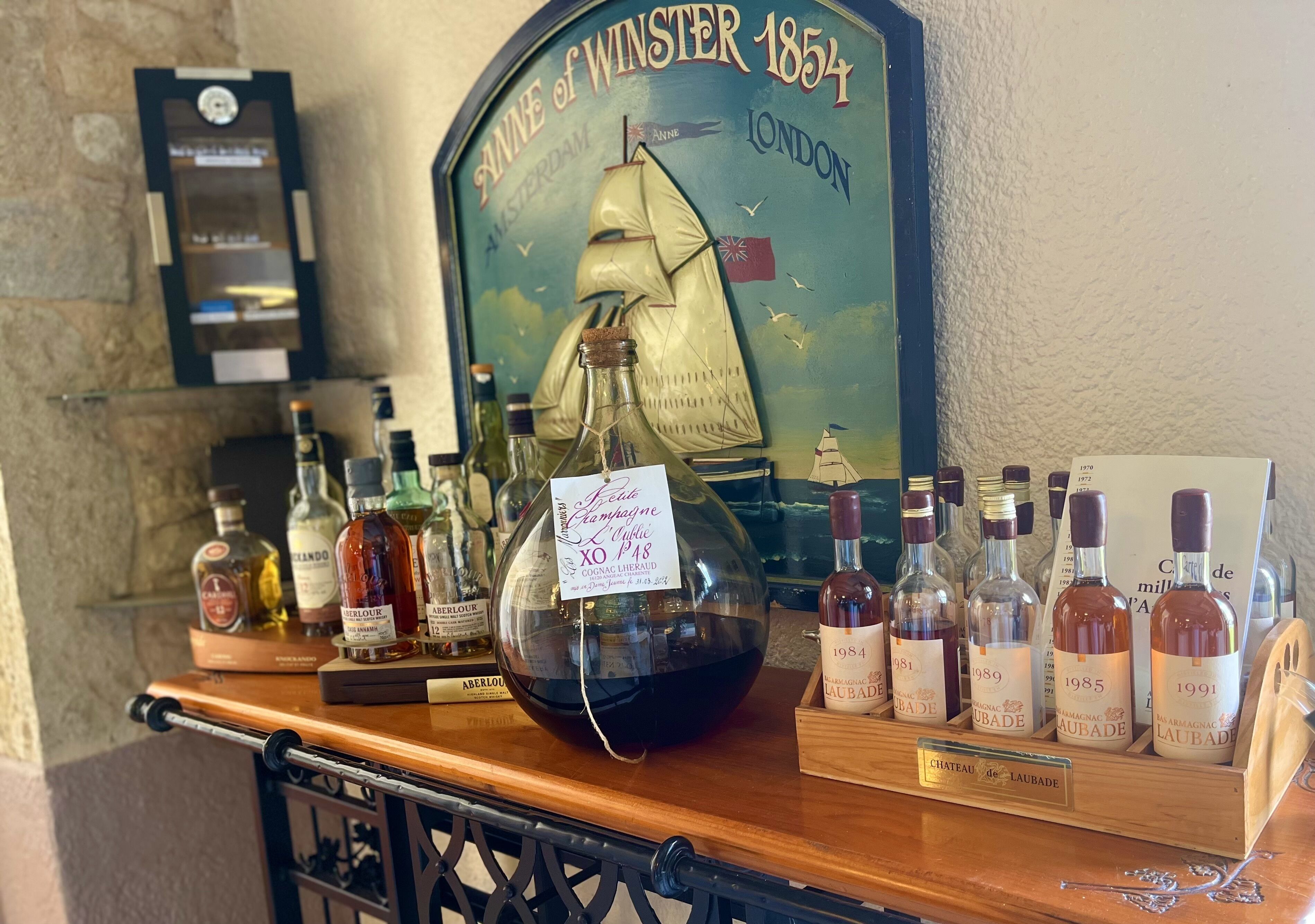A wine display with bottles and a ship-themed sign.