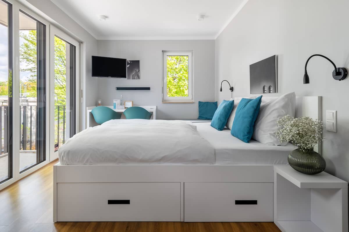 Une chambre à coucher moderne avec un grand lit, un bureau et un téléviseur.