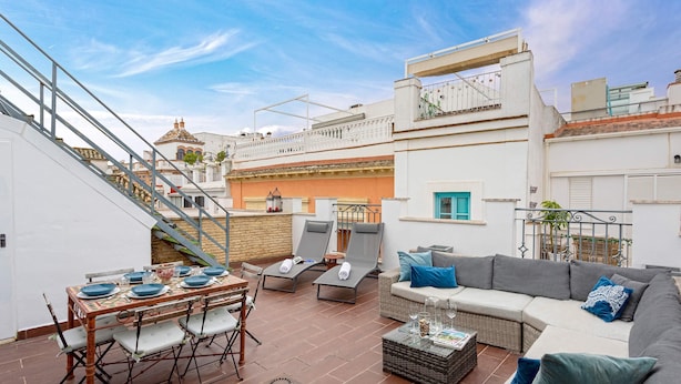 A rooftop terrace with a dining table set, lounge chairs, and a sofa. - Genteel Home Francos Terrace V (Seville)