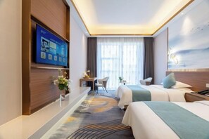 A hotel room with two beds, a desk, a chair, a TV, and a large window with curtains. - Montriche International Hotel (WEIFANG)