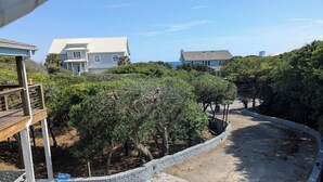 A residential area with houses, a curved driveway, and a brick wall. - Ocean View, large deck, private, nearby beach access  (Pine Knoll Shores)