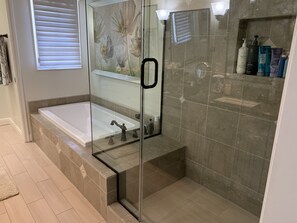 Bathtub, hair dryer, towels, toilet paper