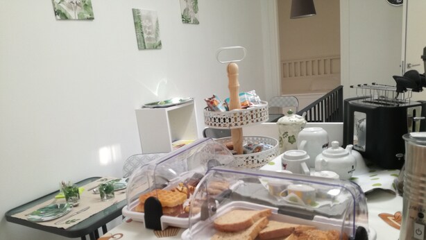 A breakfast setup with bread, a coffee maker, and a kettle on a table. - AdagioRooms (Elmas)