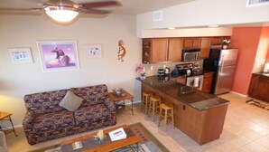 A compact kitchen with a central island, wooden cabinets, and a microwave. - Great Central Location! - Hot Tub- Red Rock Views (Sedona)