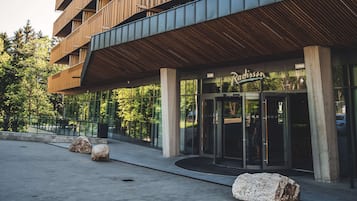 A modern building with a wooden facade and large glass windows.