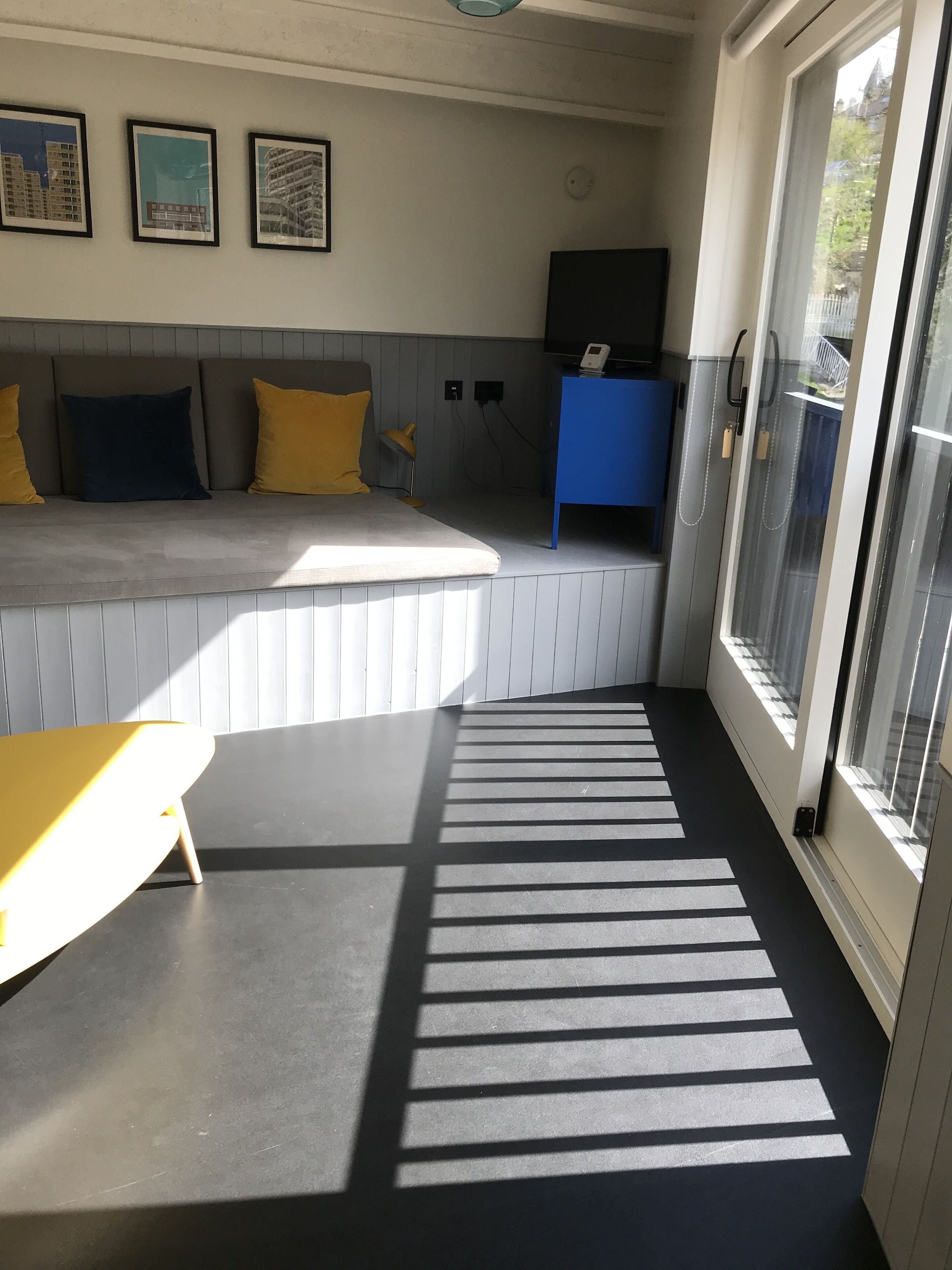 A room with a bed, a desk, and a window.