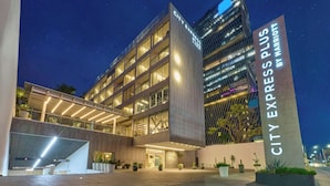 A modern hotel with a prominent "CITY EXPRESS PLUS" sign, featuring a multi-story structure with large windows and a well-lit entrance area. - City Express Plus by Marriott Guadalajara Providencia (Guadalajara)