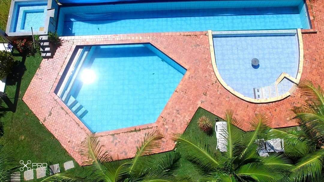 A swimming pool with a brick border and a clear blue water surface.
