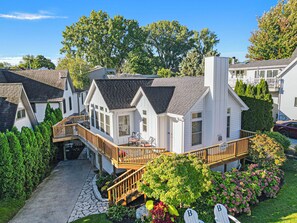 Stunning two-story house surrounded by lush gardens and a beautifully maintained outdoor space.