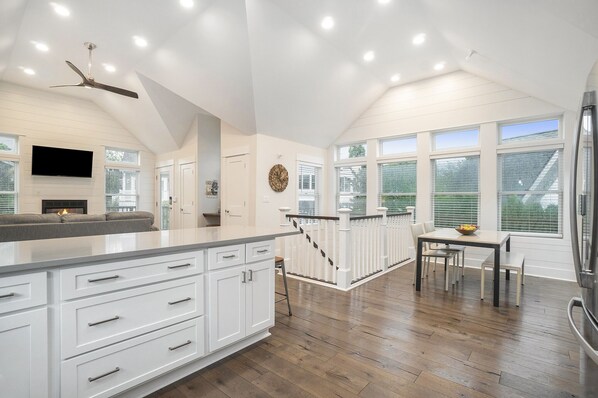 Enjoy cooking in this well-equipped kitchen with a large island, flat-screen TV, and adjacent dining area.