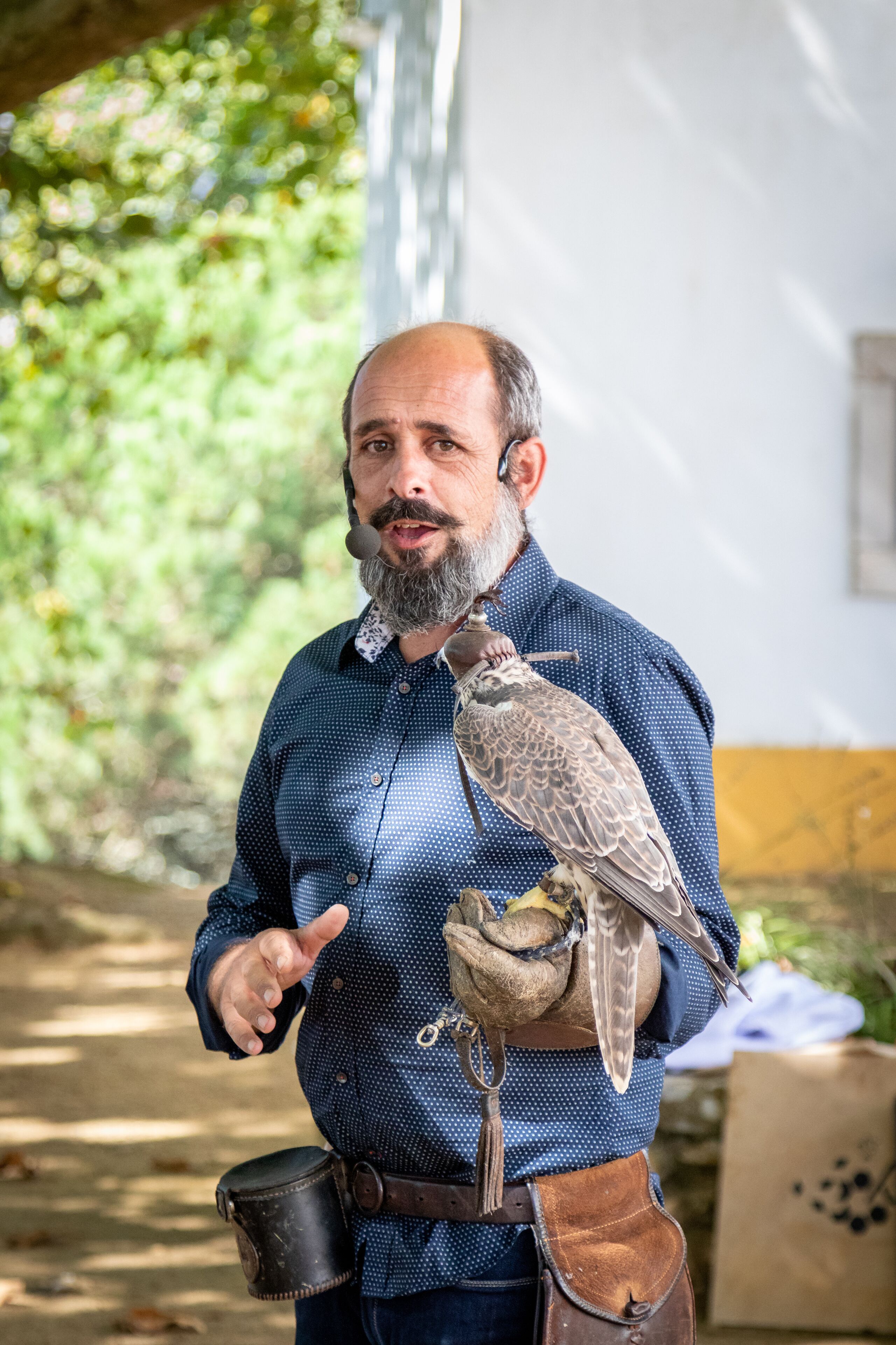 A person holding a bird of prey.