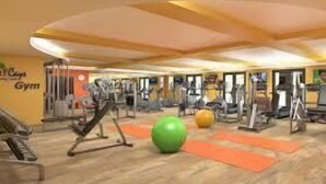 A gym with exercise equipment, a green exercise ball, and orange mats. - Relax in 2 bedroom Condo at The Cays Ocotillo!30 Night Min! (Chandler)