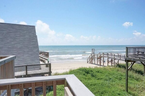 Enjoy breathtaking ocean views from this elevated deck overlooking the sandy beach.
