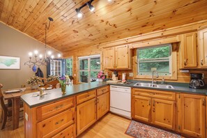 Enjoy cooking in this well-equipped kitchen with a dishwasher, sink, and ample counter space.