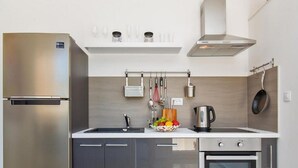 A modern kitchen with stainless steel appliances, a built-in oven, and a variety of utensils and cookware. - Apartments St.Thomas - Deluxe Two-Bedroom Apartment (Dubrovnik)