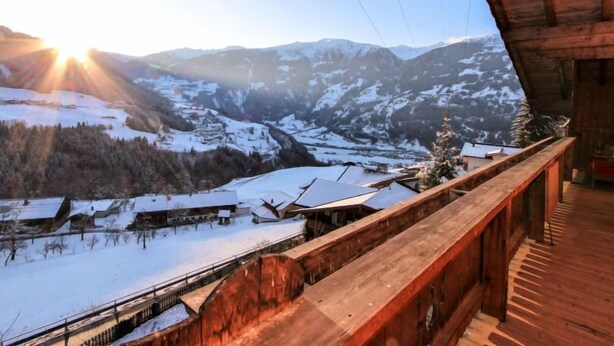 A wooden cabin with a balcony overlooking a snowy mountain valley. - Apartment Laura by Interhome (Zell am Ziller)