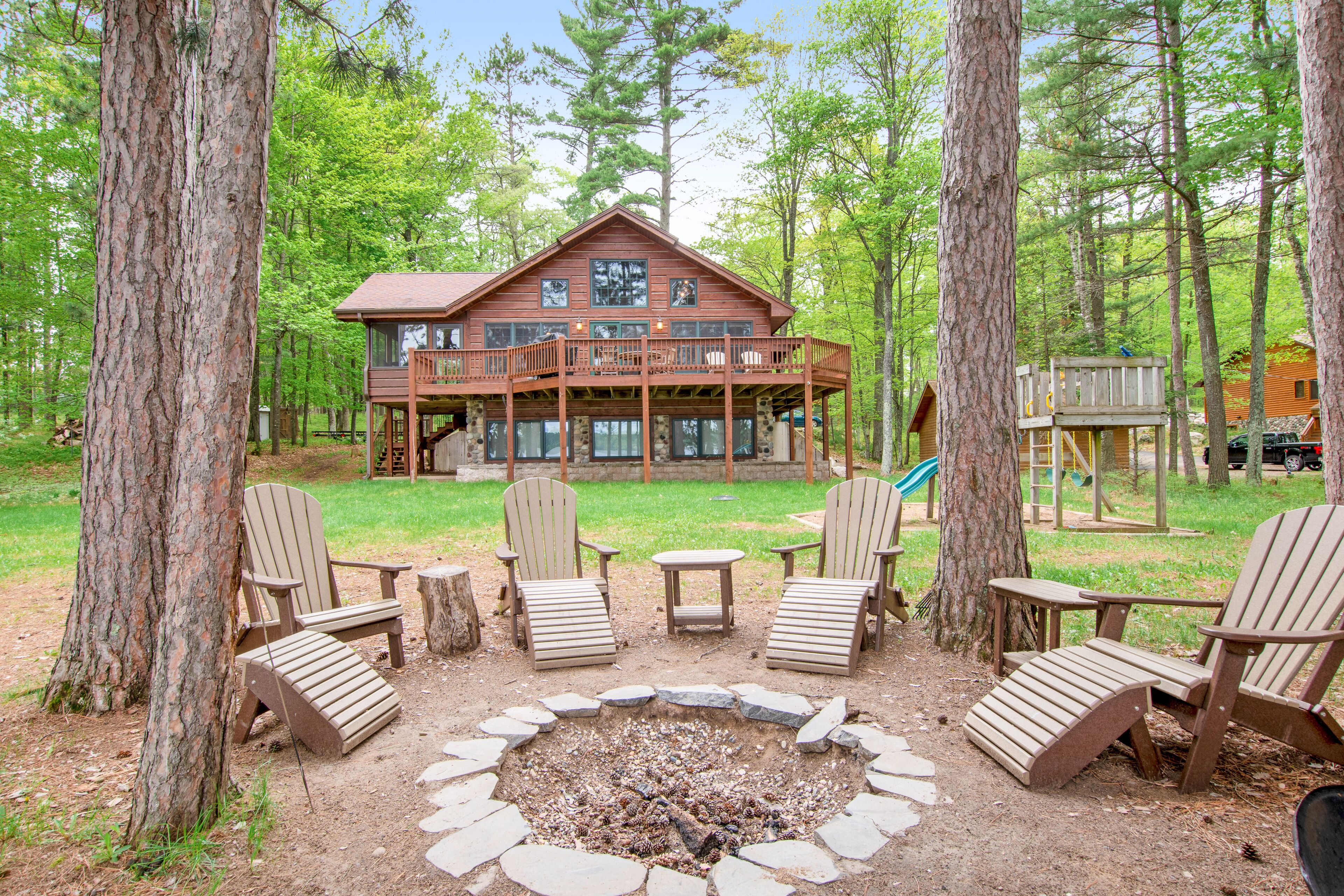 Lakefront dog-friendly home with firepit, play set, dock, & beach access