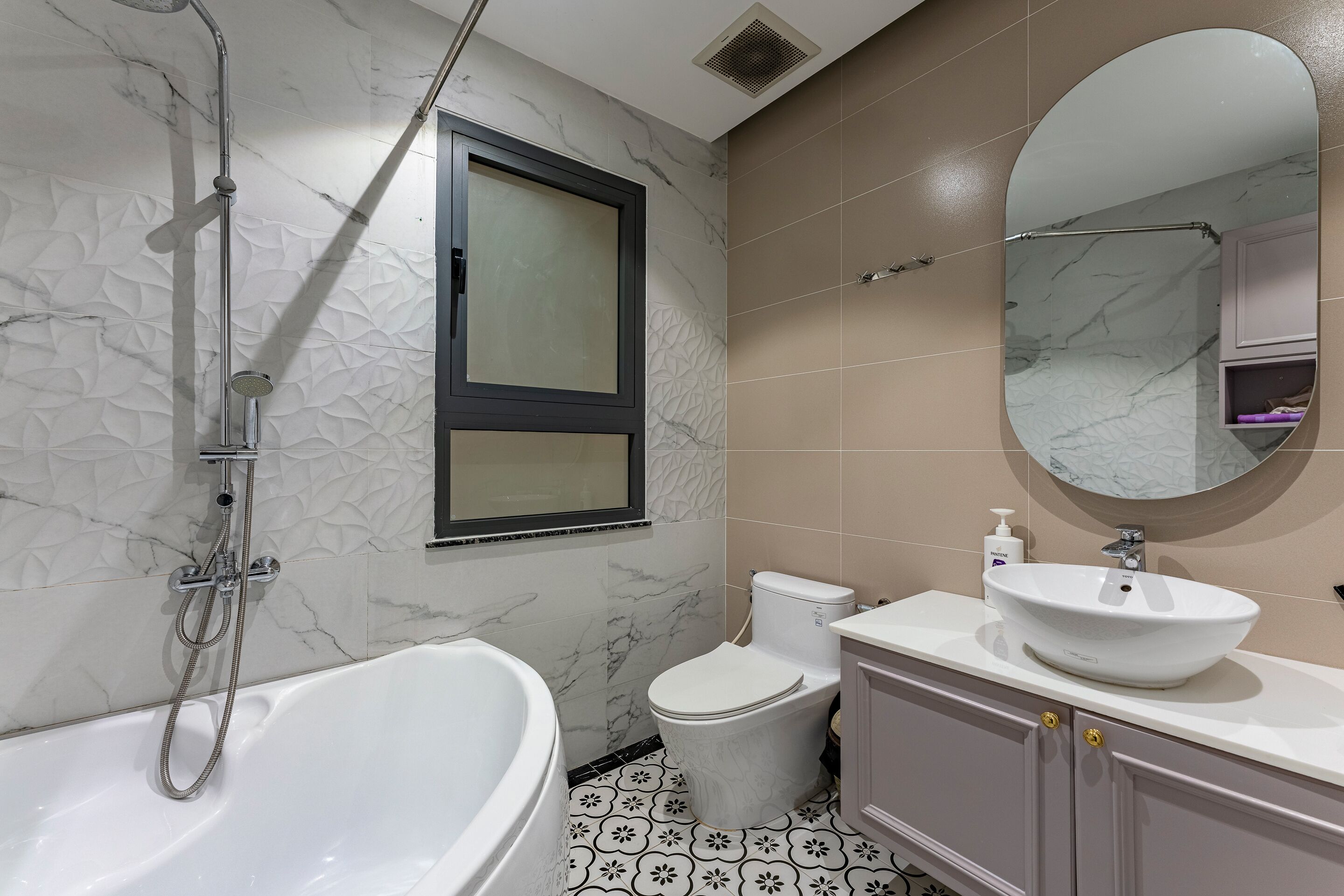 A modern bathroom with a bathtub, toilet, and sink.