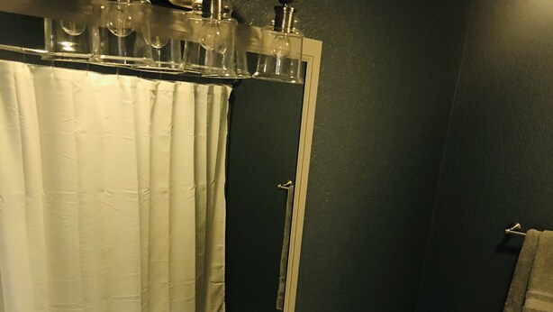 A bathroom with a white sink, a toilet, and a mirror above the sink.