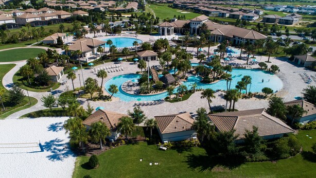 An aerial view of a resort with multiple swimming pools, palm trees, and a golf course. - Villa 9020 - Near Parks, Free Pool/Spa Heat, Game Rm, & PS5! UPDATED MAY 2026! (Champions Gate)