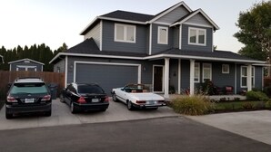 A two-story house with a garage, two cars parked in front, and a well-maintained lawn. - Beautiful home close to the Eugene Airport with easy access to downtown Eugene (Eugene)