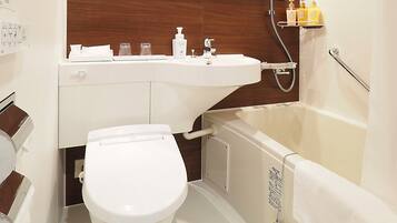 A modern bathroom with a toilet, sink, and bathtub.