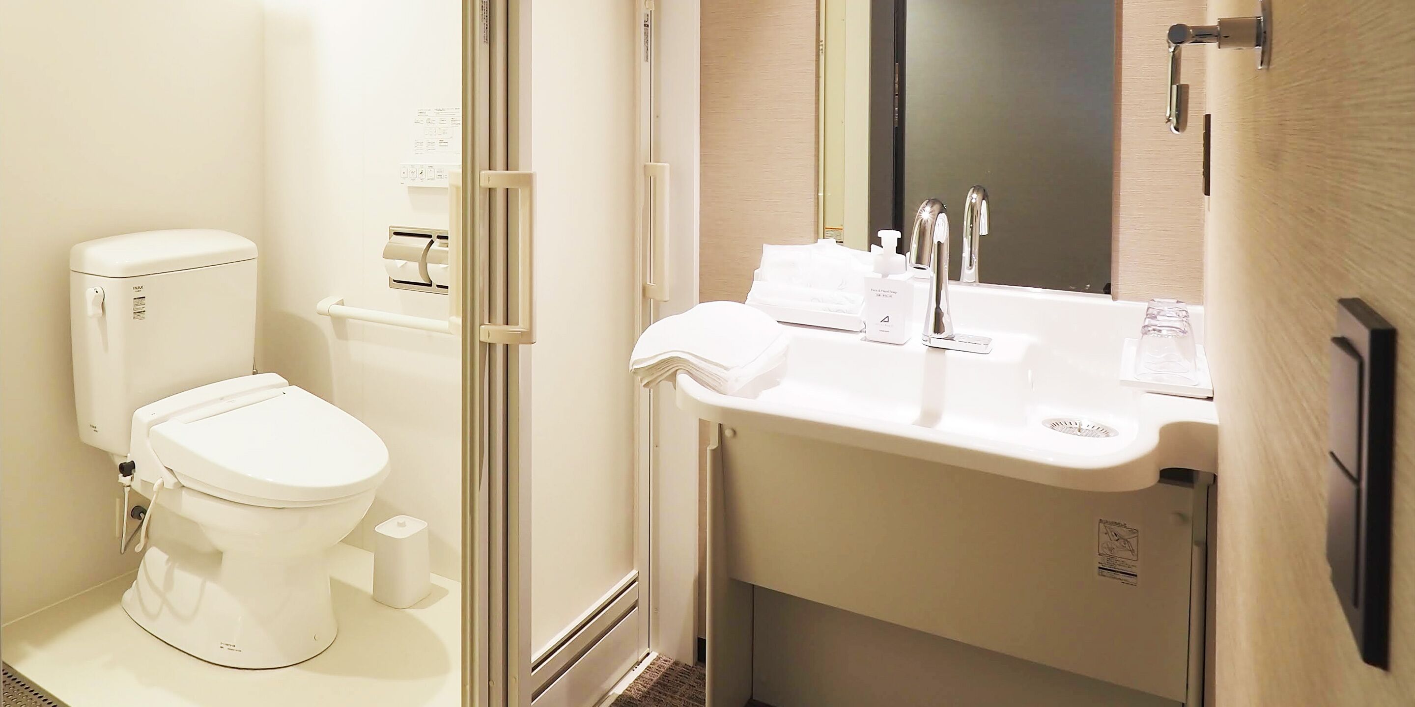 A modern bathroom with a toilet, bidet, and sink.