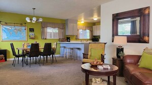 A compact living space with a dining area, kitchen, and a cozy seating area. - Quaint & Cozy Cottage: 3 Mi to Palisade Wineries! (Grand Junction)
