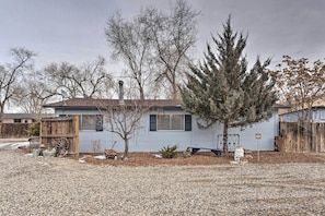 Enjoy a peaceful retreat in this cozy home surrounded by trees and a yard.