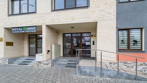 A building with a sign reading "ROYAL DENT RADIOLOGIE DIGITALA" at the entrance. - Relax Apartment Coresi Mall (Brasov)