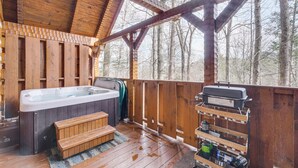 A wooden deck with a hot tub, a barbecue grill, and a wooden bench. - Honey Bear Pause: Rural Escape w/ Porch & Hot Tub! (Townsend)