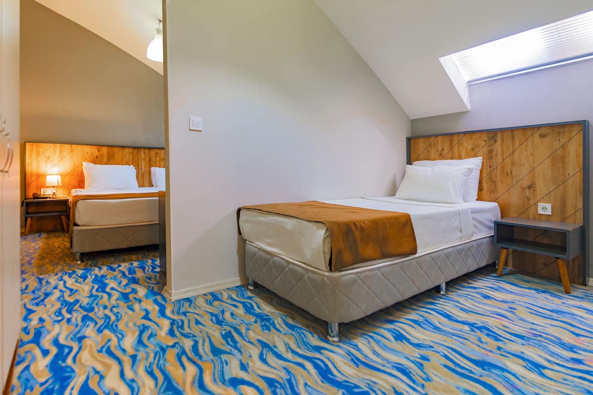 A bedroom with a bed, bedside table, and a nightstand.
